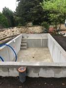 Réalisation d'une piscine en aggloméré de ciment à bancher enduite